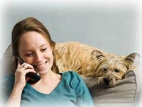 photo: woman on phone, dog looking at her. Contact Peleope Jensen